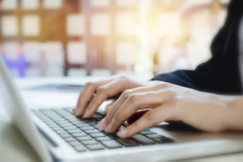 Person typing on laptop