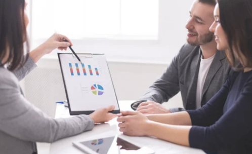 Couple reviewing paperwork with financial advisor